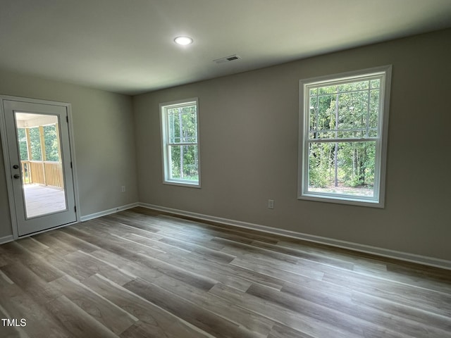 226 Bonsai Way, Four Oaks, NC 27524 - empty room with plenty of natural light, wood finished floors, and recessed lighting