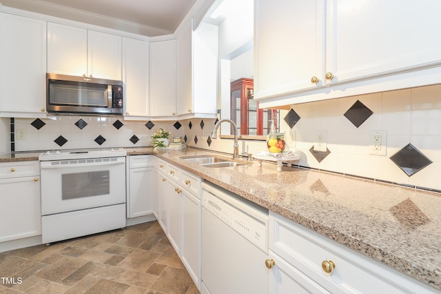 128 Olde Manor Ct, Siler City, NC 27344 - kitchen with white appliances, a sink, white cabinets, stone finish flooring, and decorative backsplash
