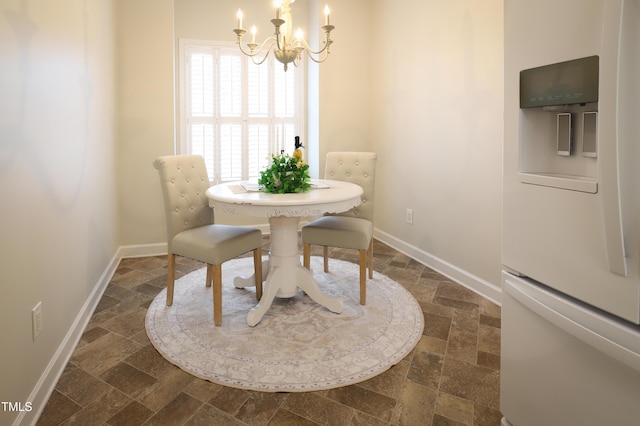 128 Olde Manor Ct, Siler City, NC 27344 - dining space featuring stone tile flooring, a chandelier, and baseboards