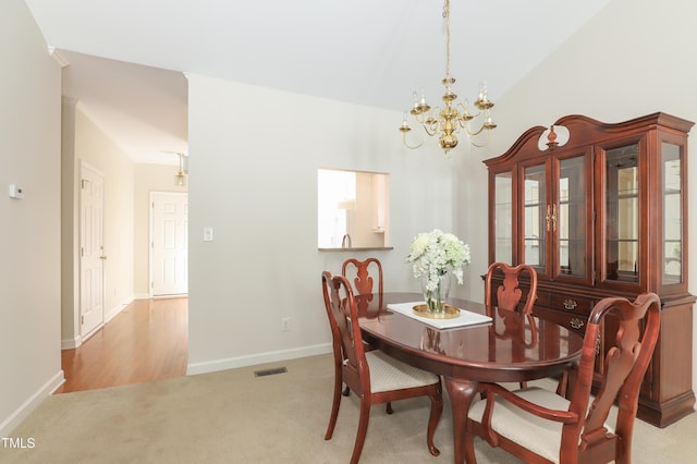 128 Olde Manor Ct, Siler City, NC 27344 - carpeted dining space featuring a chandelier, baseboards, and vaulted ceiling