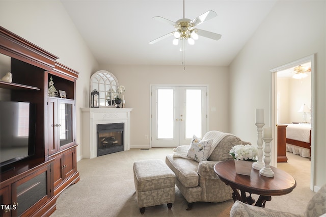 128 Olde Manor Ct, Siler City, NC 27344 - living room featuring light carpet, a ceiling fan, vaulted ceiling, french doors, and a fireplace