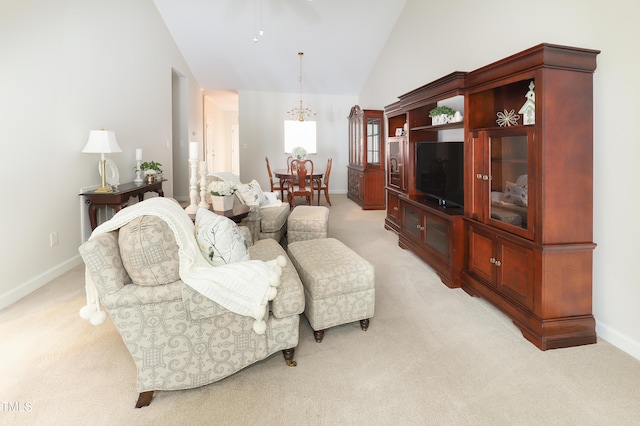 128 Olde Manor Ct, Siler City, NC 27344 - living area featuring light carpet, a chandelier, baseboards, a ceiling fan, and high vaulted ceiling
