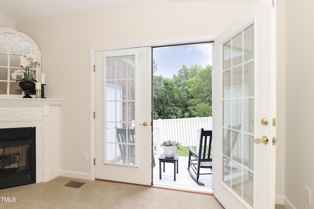 128 Olde Manor Ct, Siler City, NC 27344 - doorway to outside with plenty of natural light, carpet, baseboards, and a glass covered fireplace