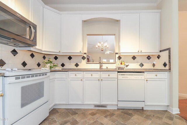 128 Olde Manor Ct, Siler City, NC 27344 - kitchen featuring white appliances, a chandelier, light stone finish flooring, a sink, and white cabinets