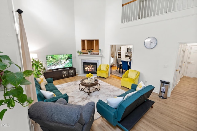 4705 Royal Troon Dr, Raleigh, NC 27604 - living room with a high ceiling, wood finished floors, a fireplace, and baseboards