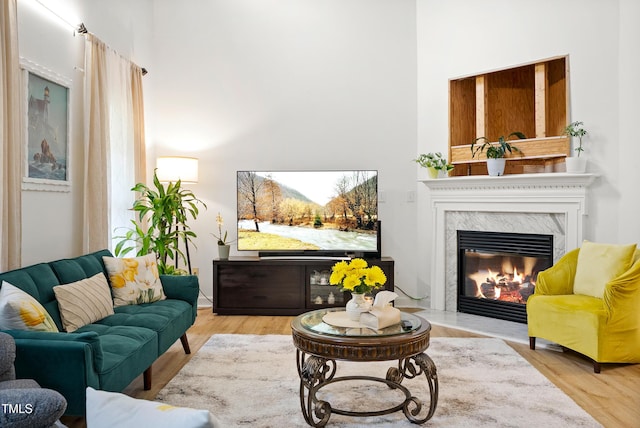 4705 Royal Troon Dr, Raleigh, NC 27604 - living room featuring a towering ceiling, a fireplace, and wood finished floors