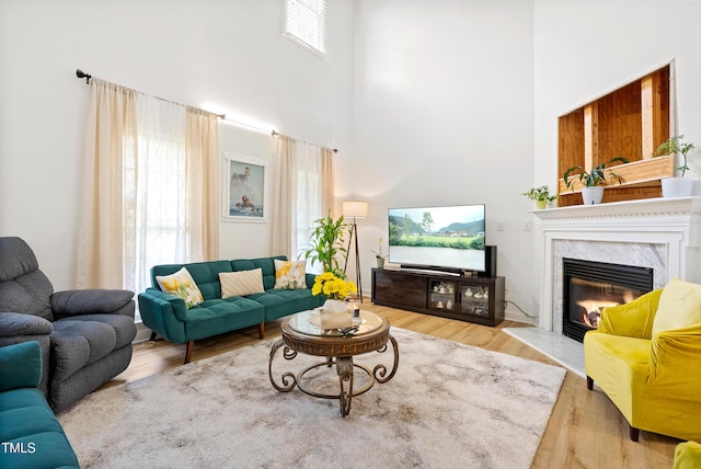 4705 Royal Troon Dr, Raleigh, NC 27604 - living room featuring a high end fireplace, a towering ceiling, and wood finished floors