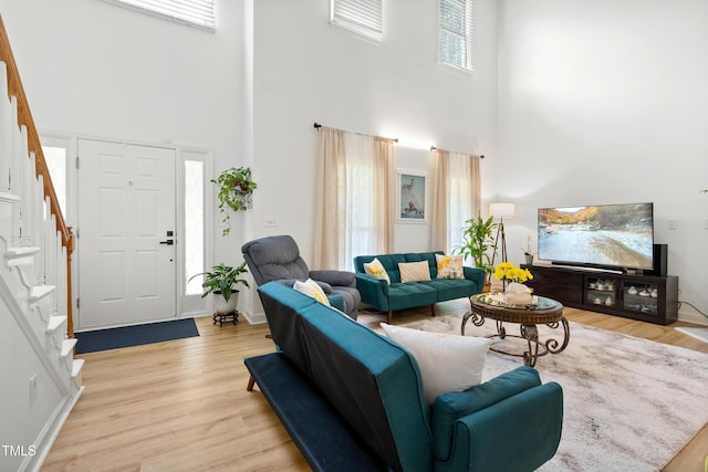 4705 Royal Troon Dr, Raleigh, NC 27604 - living room with a high ceiling, light wood-style floors, and stairs