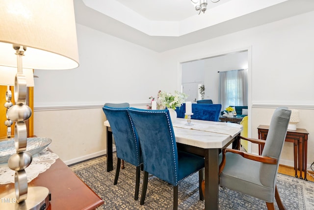 4705 Royal Troon Dr, Raleigh, NC 27604 - dining space with a raised ceiling, baseboards, and wood finished floors