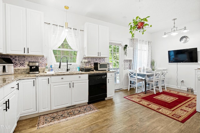 4705 Royal Troon Dr, Raleigh, NC 27604 - kitchen featuring dishwasher, a sink, light wood-style floors, and tasteful backsplash