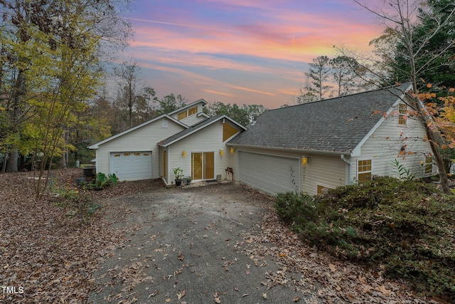 103 Pony Express Cv, Louisburg, NC 27549 - view of front of property with a garage, asphalt driveway, a shingled roof, and central AC unit