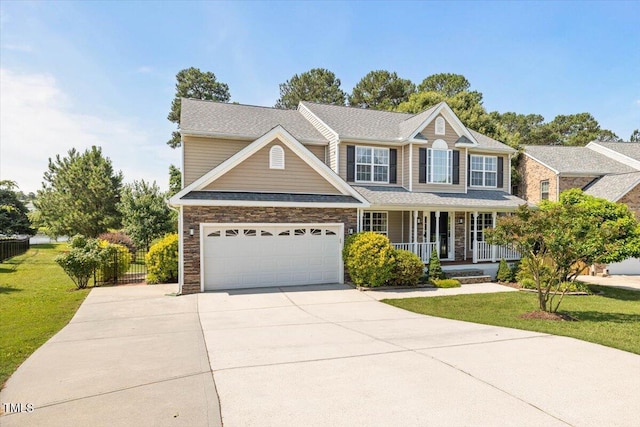 947 Middle Ground Ave, Rolesville, NC 27571 - view of front of property featuring a porch, driveway, stone siding, and an attached garage