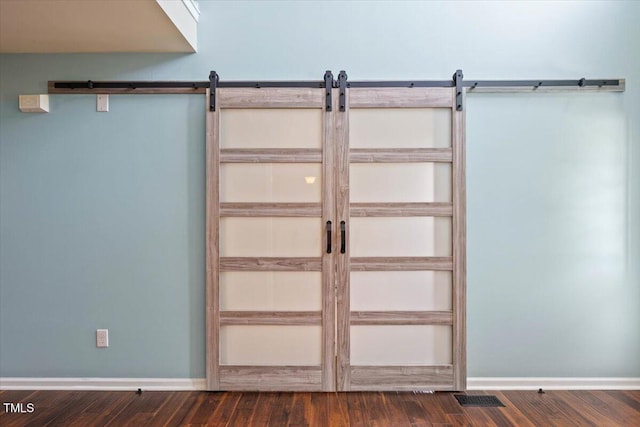 947 Middle Ground Ave, Rolesville, NC 27571 - detailed view of a barn door, wood finished floors, and baseboards