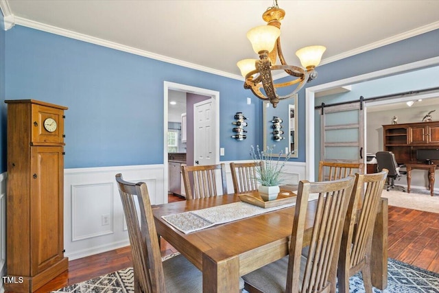 947 Middle Ground Ave, Rolesville, NC 27571 - dining area with a chandelier, dark wood-type flooring, a barn door, crown molding, and a decorative wall