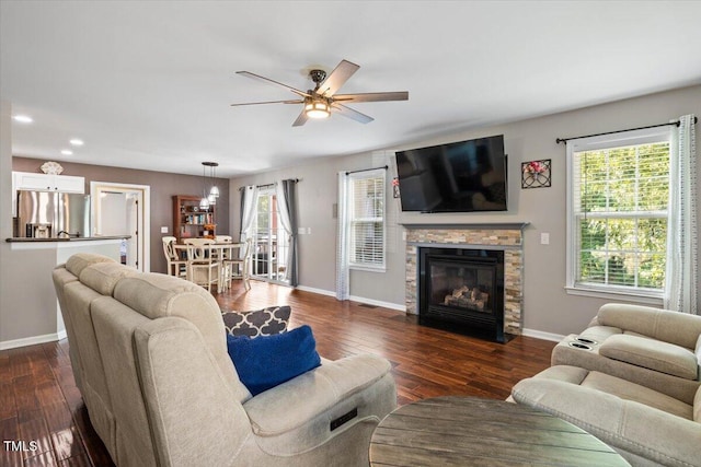 947 Middle Ground Ave, Rolesville, NC 27571 - living area featuring ceiling fan, baseboards, recessed lighting, dark wood-style floors, and a stone fireplace