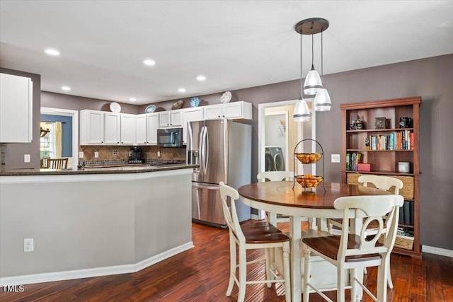 947 Middle Ground Ave, Rolesville, NC 27571 - kitchen with stainless steel appliances, dark wood-style floors, white cabinets, backsplash, and a peninsula