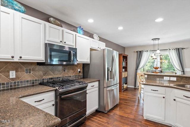 947 Middle Ground Ave, Rolesville, NC 27571 - kitchen with stainless steel appliances, white cabinets, dark wood-style floors, tasteful backsplash, and recessed lighting