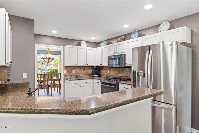 947 Middle Ground Ave, Rolesville, NC 27571 - kitchen featuring stainless steel appliances, dark stone countertops, tasteful backsplash, white cabinetry, and recessed lighting