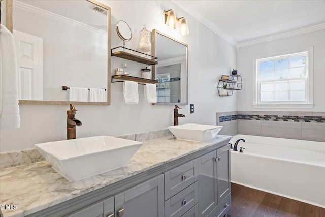 947 Middle Ground Ave, Rolesville, NC 27571 - bathroom with wood finished floors, crown molding, double vanity, and a garden tub