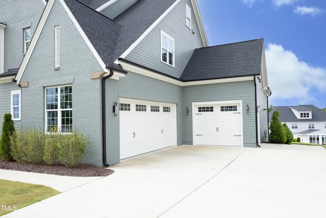 7736 Roberts Rd, Apex, NC 27523 - view of property exterior featuring concrete driveway, roof with shingles, and an attached garage