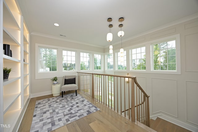 7736 Roberts Rd, Apex, NC 27523 - sitting room with wood finished floors, an upstairs landing, crown molding, baseboards, and a decorative wall