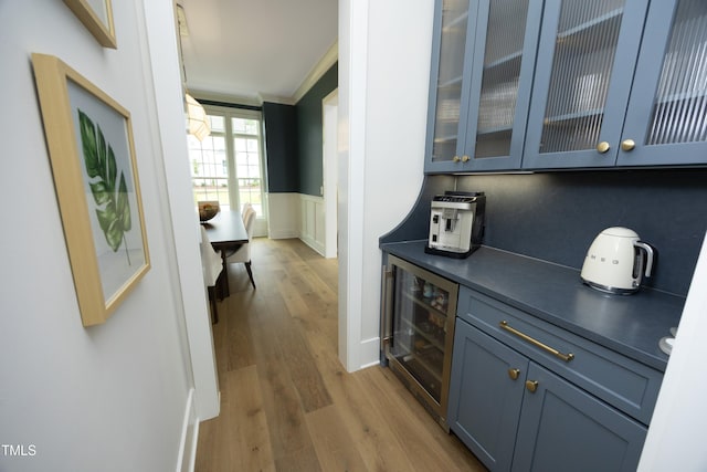 7736 Roberts Rd, Apex, NC 27523 - bar with beverage cooler, wood finished floors, wainscoting, and a decorative wall