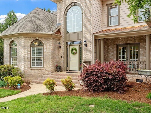 2207 Cameron Pond Dr, Cary, NC 27519 - view of front of property featuring brick siding, a standing seam roof, a shingled roof, and metal roof