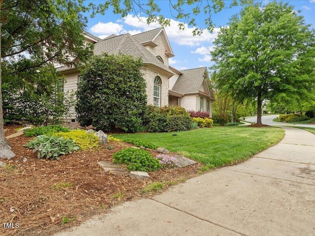 2207 Cameron Pond Dr, Cary, NC 27519 - view of side of home with a lawn and a shingled roof