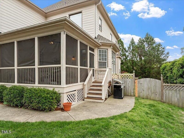 2207 Cameron Pond Dr, Cary, NC 27519 - view of home's exterior featuring a sunroom, a gate, and roof with shingles