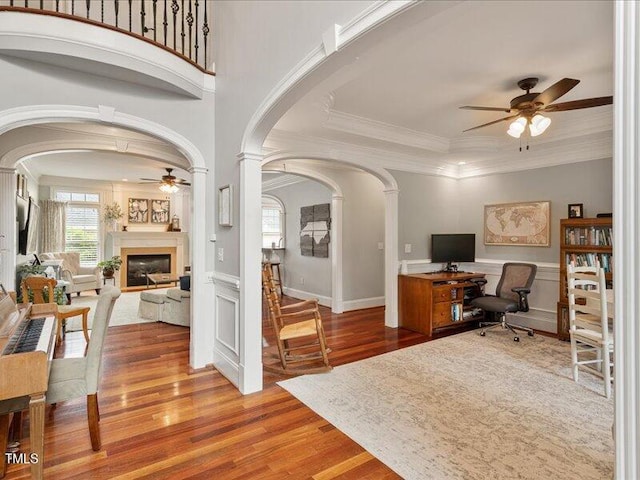 2207 Cameron Pond Dr, Cary, NC 27519 - office space featuring ceiling fan, wood finished floors, a glass covered fireplace, decorative columns, and crown molding