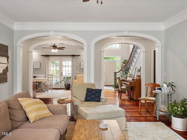 2207 Cameron Pond Dr, Cary, NC 27519 - living area featuring arched walkways, a ceiling fan, crown molding, wood finished floors, and stairway
