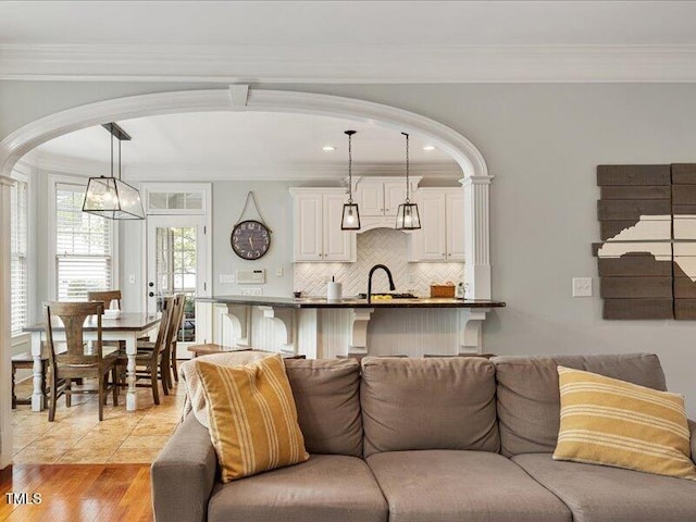 2207 Cameron Pond Dr, Cary, NC 27519 - living room featuring arched walkways, ornamental molding, and recessed lighting