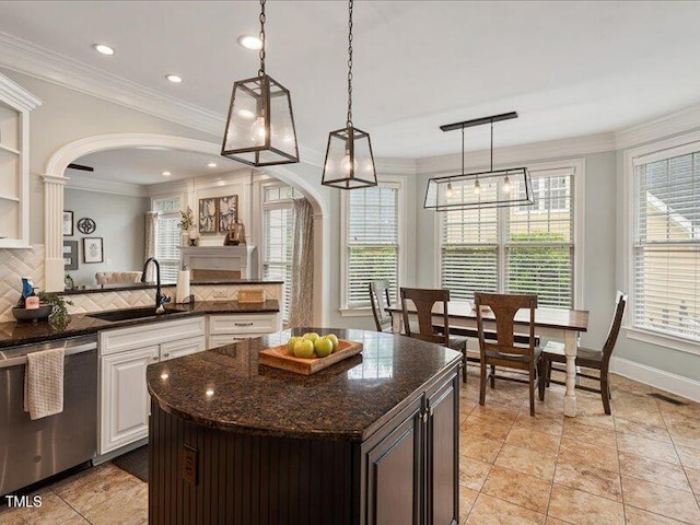 2207 Cameron Pond Dr, Cary, NC 27519 - kitchen with dishwasher, a sink, arched walkways, plenty of natural light, and crown molding