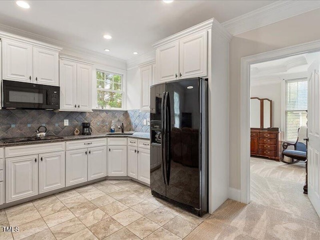 2207 Cameron Pond Dr, Cary, NC 27519 - kitchen with black appliances, ornamental molding, a sink, white cabinets, and decorative backsplash