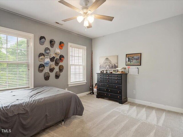 2207 Cameron Pond Dr, Cary, NC 27519 - bedroom with baseboards, multiple windows, light colored carpet, and a ceiling fan