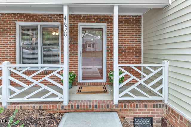 4658 Fawnbrook Cir, Raleigh, NC 27612 - view of exterior entry with a porch and brick siding