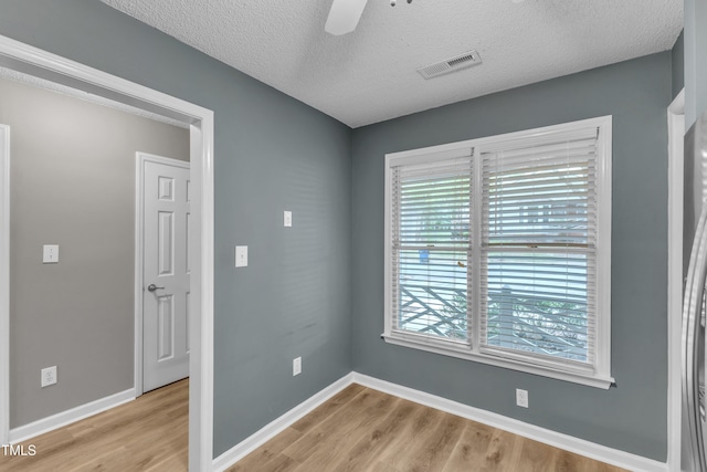 4658 Fawnbrook Cir, Raleigh, NC 27612 - spare room featuring light wood finished floors, plenty of natural light, baseboards, and a textured ceiling
