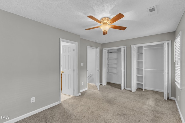 4658 Fawnbrook Cir, Raleigh, NC 27612 - unfurnished bedroom with two closets, carpet floors, baseboards, a textured ceiling, and ceiling fan