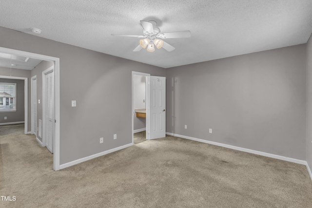 4658 Fawnbrook Cir, Raleigh, NC 27612 - unfurnished bedroom featuring attic access, light carpet, baseboards, a textured ceiling, and connected bathroom