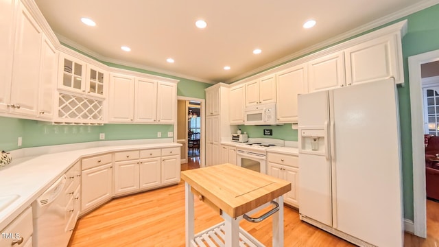119 Georgetowne Dr, Elon, NC 27244 - kitchen featuring white appliances, crown molding, light countertops, light wood finished floors, and white cabinetry