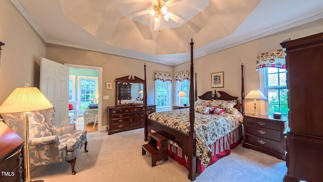 119 Georgetowne Dr, Elon, NC 27244 - bedroom featuring light carpet, ornamental molding, a tray ceiling, and a ceiling fan