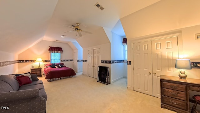 119 Georgetowne Dr, Elon, NC 27244 - bedroom with carpet flooring, lofted ceiling, a ceiling fan, and two closets