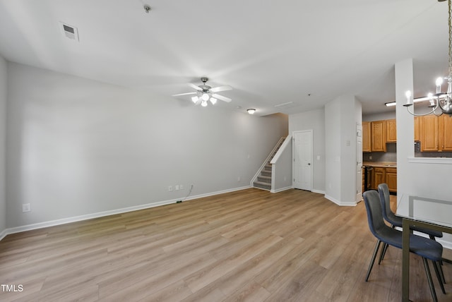 8621 Neuse Club Ln Unit 106, Raleigh, NC 27616 - unfurnished living room featuring light wood-type flooring, stairway, baseboards, and a ceiling fan