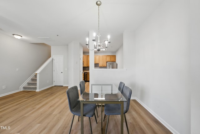 8621 Neuse Club Ln Unit 106, Raleigh, NC 27616 - dining space with a chandelier, light wood-style floors, stairs, and baseboards