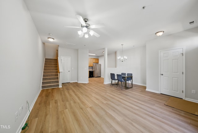 8621 Neuse Club Ln Unit 106, Raleigh, NC 27616 - living room with a ceiling fan, stairway, baseboards, a chandelier, and light wood finished floors