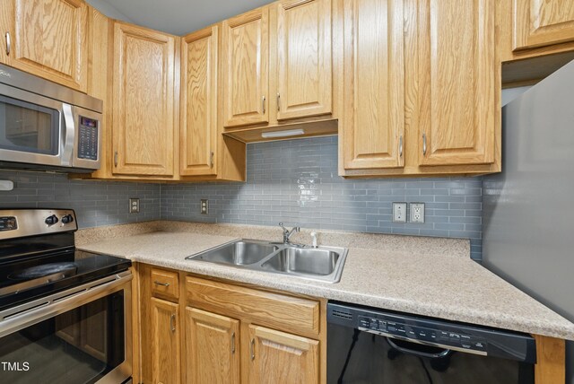 8621 Neuse Club Ln Unit 106, Raleigh, NC 27616 - kitchen featuring appliances with stainless steel finishes, a sink, light countertops, and light brown cabinetry