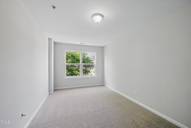 8621 Neuse Club Ln Unit 106, Raleigh, NC 27616 - unfurnished room with fire sprinkler in ceiling, carpet, and baseboards