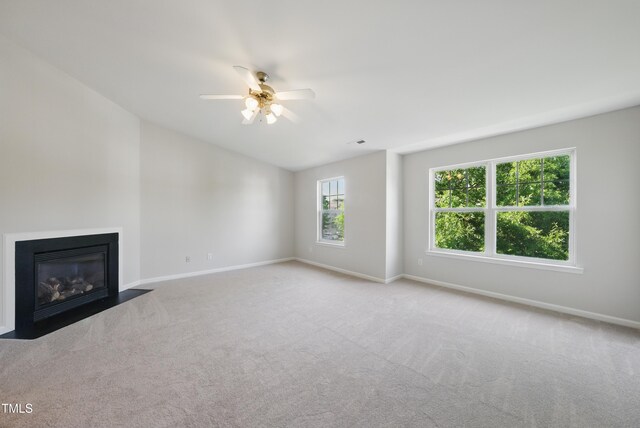 8621 Neuse Club Ln Unit 106, Raleigh, NC 27616 - unfurnished living room featuring ceiling fan, carpet, baseboards, lofted ceiling, and a fireplace with flush hearth