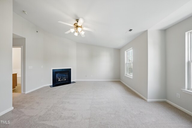 8621 Neuse Club Ln Unit 106, Raleigh, NC 27616 - unfurnished living room with light carpet, a fireplace with flush hearth, a ceiling fan, and baseboards