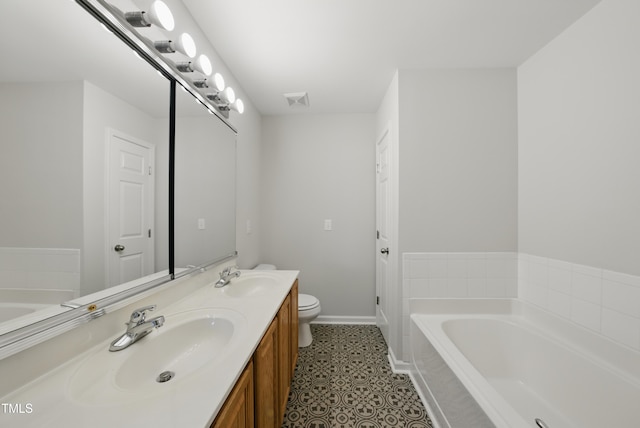 8621 Neuse Club Ln Unit 106, Raleigh, NC 27616 - bathroom featuring double vanity, toilet, a bath, and baseboards